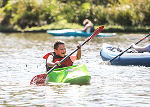 Youth paddling kayak